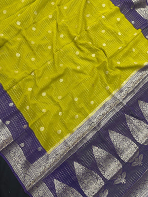 “Woman draped in a Semi Khaddi Georgette saree featuring intricate Banarasi motifs and a soft, flowy texture—perfect blend of tradition and lightness.”