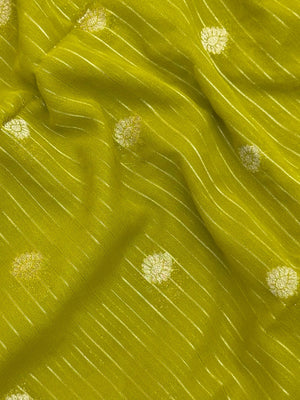 “Woman draped in a Semi Khaddi Georgette saree featuring intricate Banarasi motifs and a soft, flowy texture—perfect blend of tradition and lightness.”