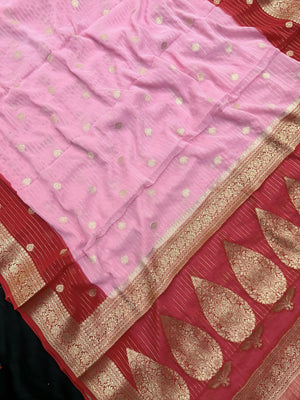 “Woman draped in a Semi Khaddi Georgette saree featuring intricate Banarasi motifs and a soft, flowy texture—perfect blend of tradition and lightness.”