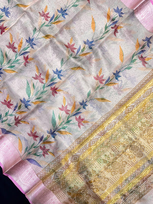 Woman in a shimmering Tissue Silk Saree with soft gold sheen, perfect for weddings and festive events.