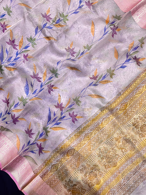 Woman in a shimmering Tissue Silk Saree with soft gold sheen, perfect for weddings and festive events.