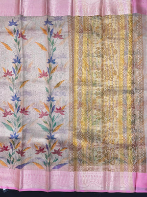 Woman in a shimmering Tissue Silk Saree with soft gold sheen, perfect for weddings and festive events.