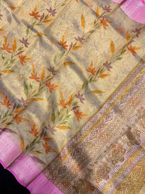 Woman in a shimmering Tissue Silk Saree with soft gold sheen, perfect for weddings and festive events.