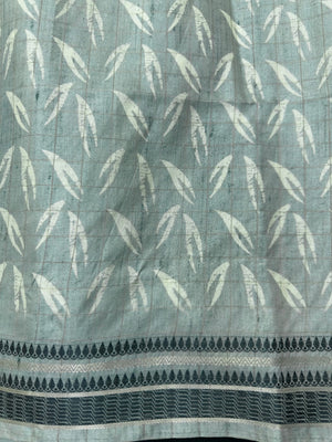 “Woman wearing a lightweight Tussar silk saree in earthy tones, featuring a soft natural sheen and subtle patterns—ideal for elegant daily wear.”