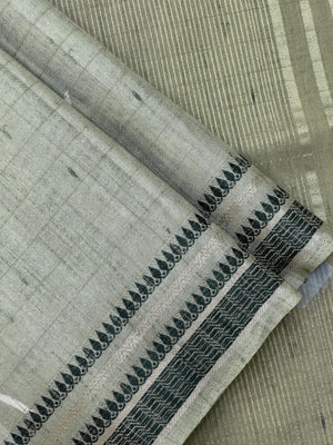 “Woman wearing a lightweight Tussar silk saree in earthy tones, featuring a soft natural sheen and subtle patterns—ideal for elegant daily wear.”