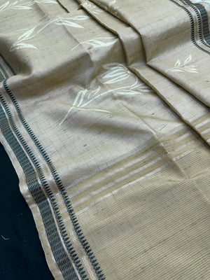 “Woman wearing a lightweight Tussar silk saree in earthy tones, featuring a soft natural sheen and subtle patterns—ideal for elegant daily wear.”