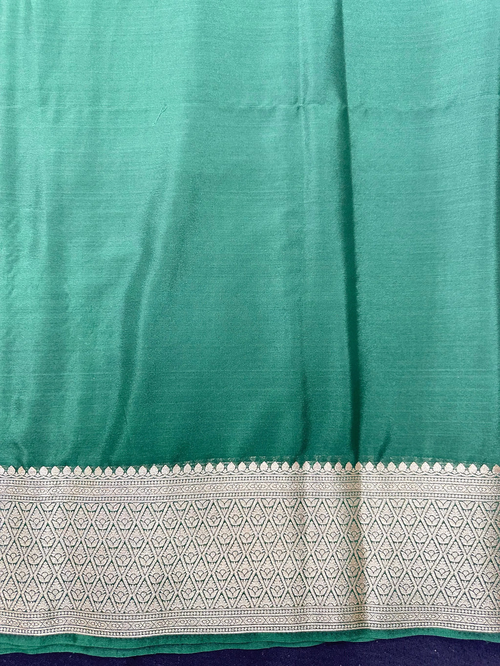 Woman wearing a Binny Crepe Saree with soft, flowing drape and minimal sheen, ideal for office and everyday wear.