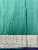 Woman wearing a Binny Crepe Saree with soft, flowing drape and minimal sheen, ideal for office and everyday wear.
