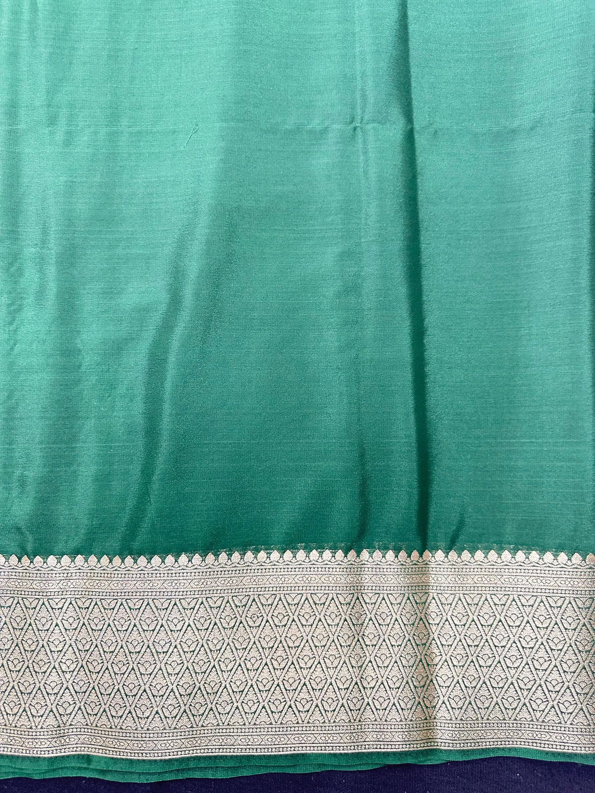 Woman wearing a Binny Crepe Saree with soft, flowing drape and minimal sheen, ideal for office and everyday wear.