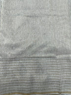 Woman wearing a Linen Silk Saree with soft, breathable texture and subtle shine, ideal for office wear and casual festive occasions.