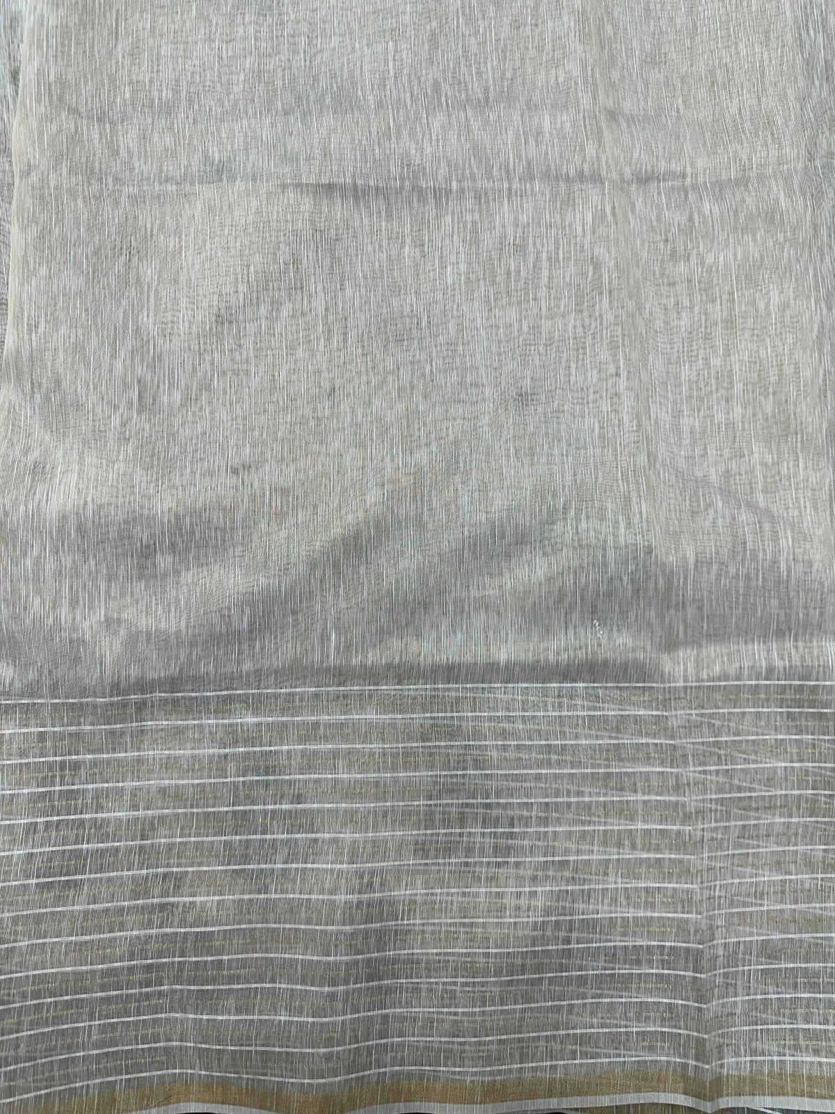 Woman wearing a Linen Silk Saree with soft, breathable texture and subtle shine, ideal for office wear and casual festive occasions.