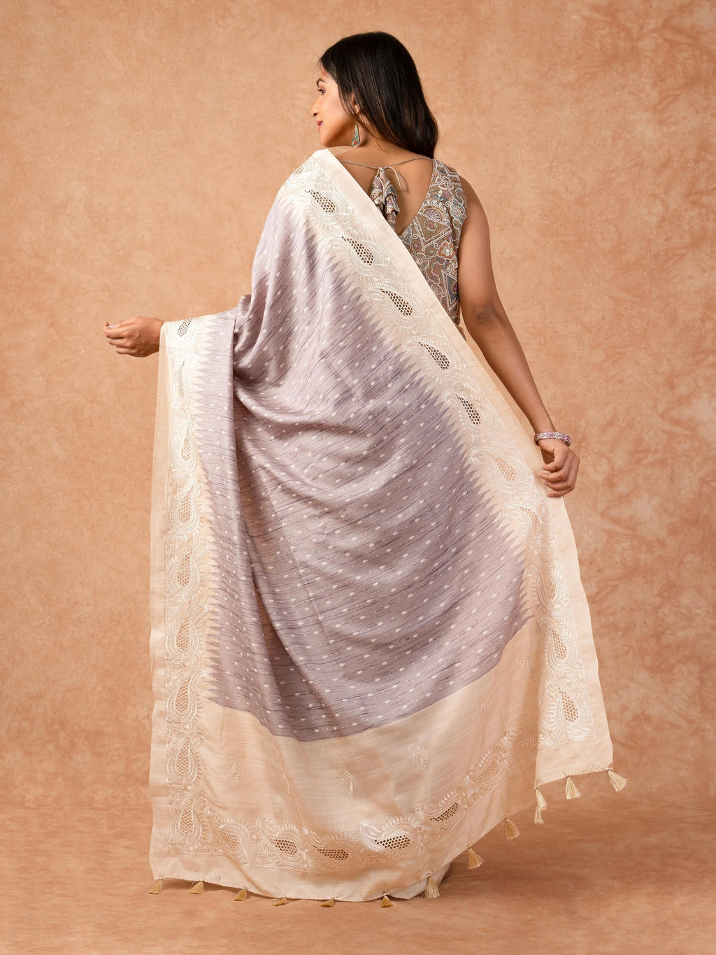Woman wearing a Milky Cutwork Tussar Silk Saree with delicate embroidery and soft drape, ideal for weddings, receptions, and festive occasions.