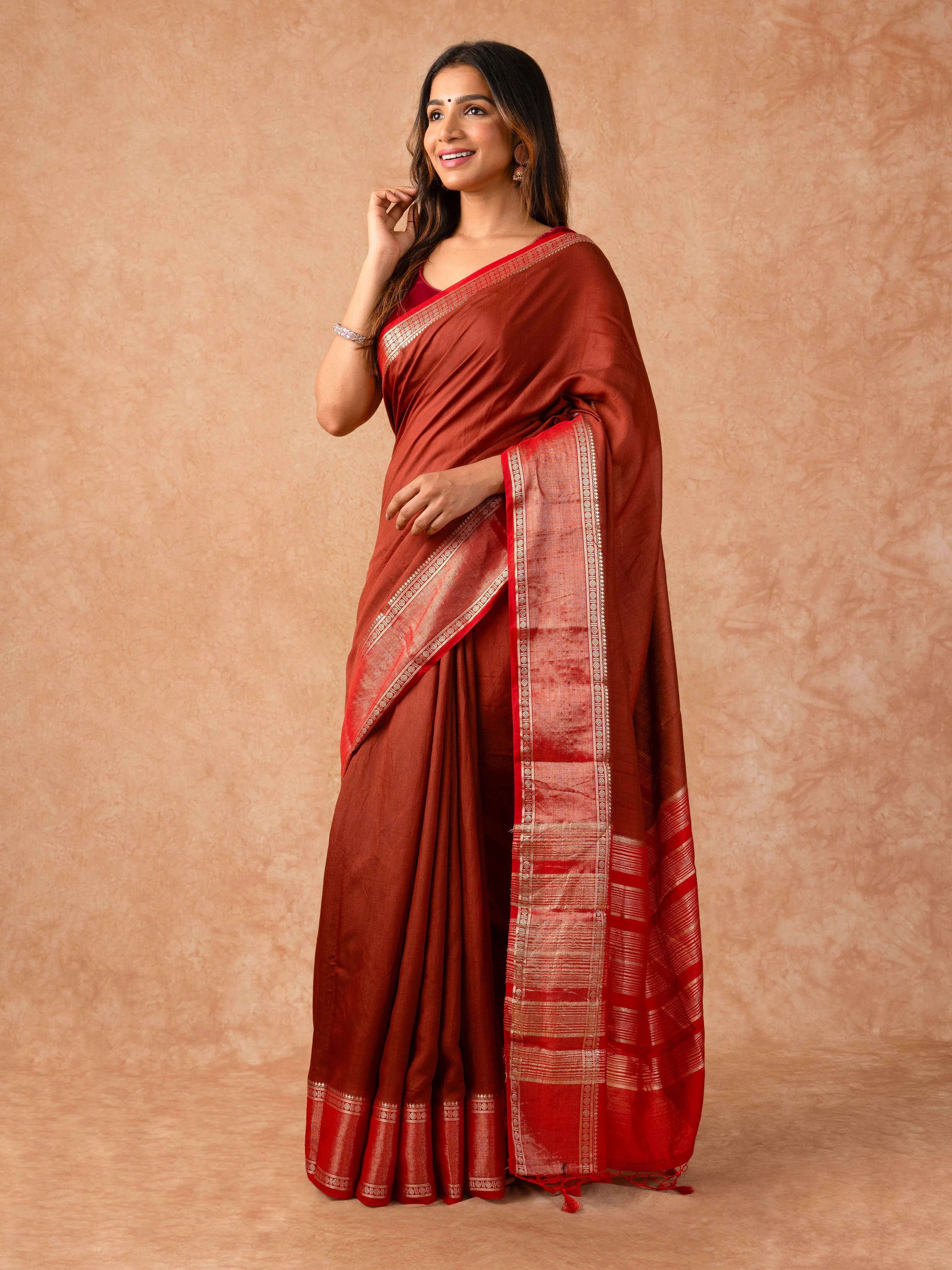 Woman wearing a Muggum Silk Saree with intricate embroidery and rich silk fabric, ideal for weddings, festivals, and traditional events.