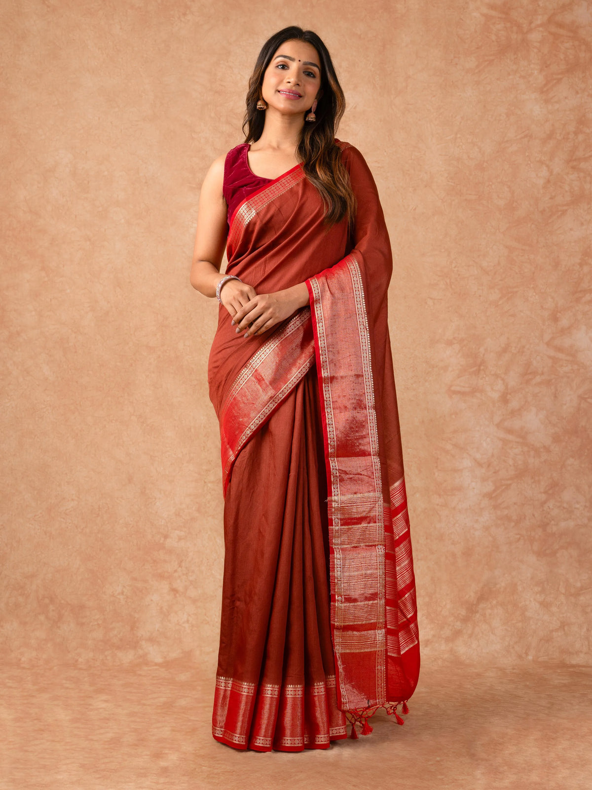 Woman wearing a Muggum Silk Saree with intricate embroidery and rich silk fabric, ideal for weddings, festivals, and traditional events.