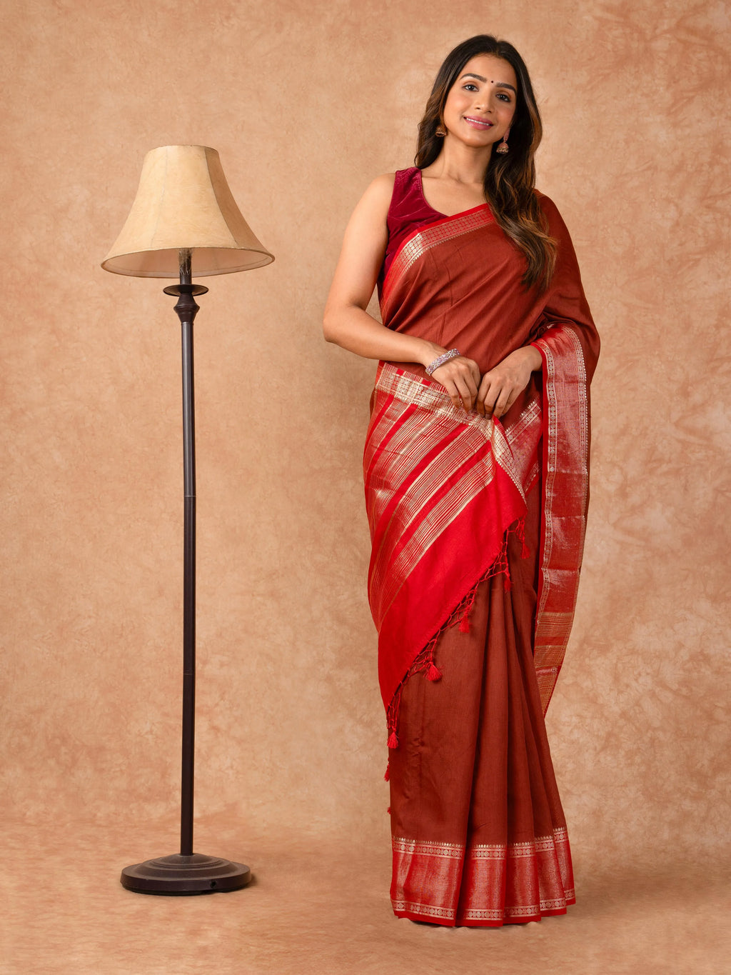 Woman wearing a Muggum Silk Saree with intricate embroidery and rich silk fabric, ideal for weddings, festivals, and traditional events.