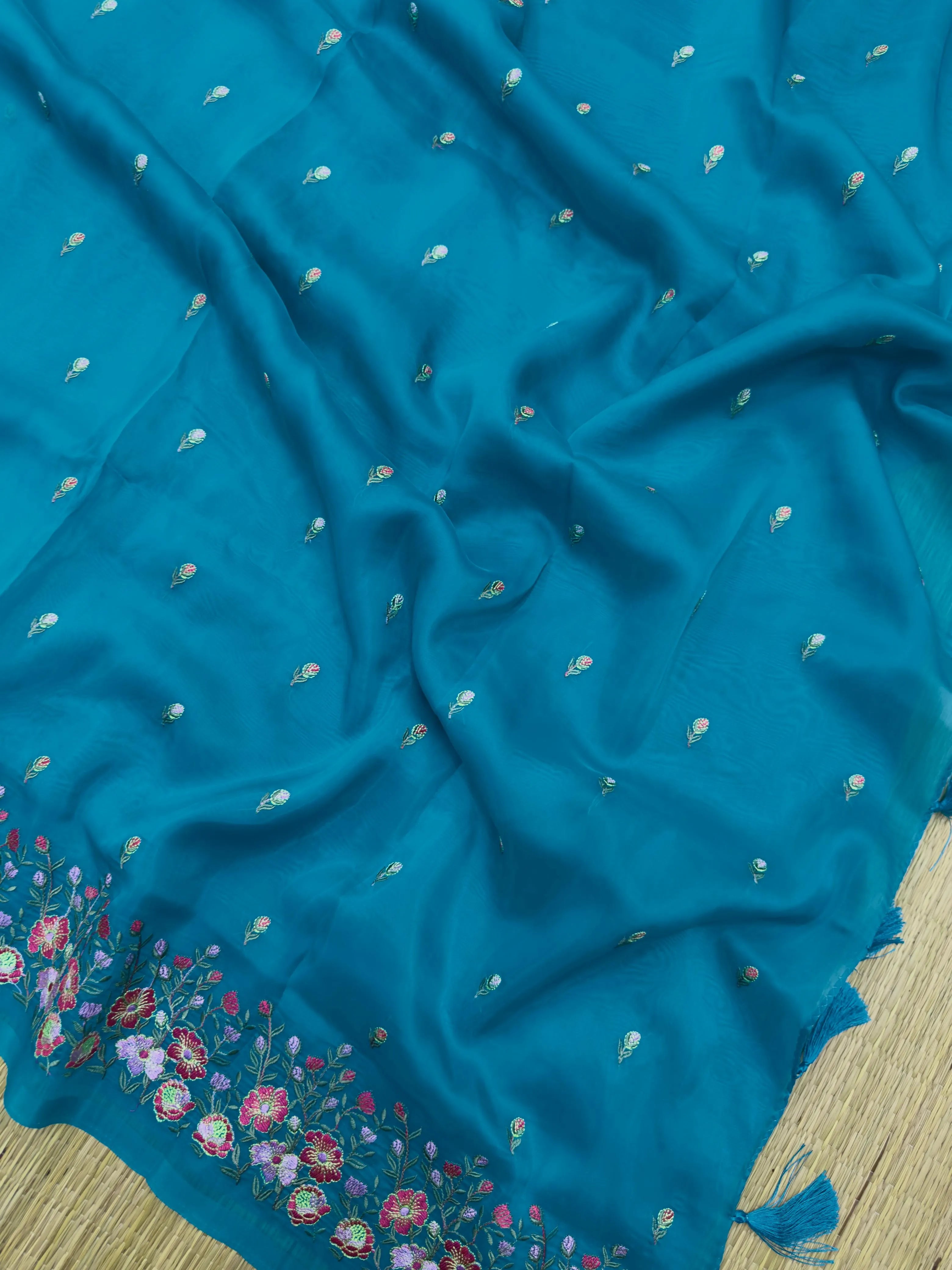 A stunning Organza Saree with a delicate sheen, designed for fancy and party wear. The lightweight, airy fabric drapes beautifully, adding glamour and elegance to any special occasion.