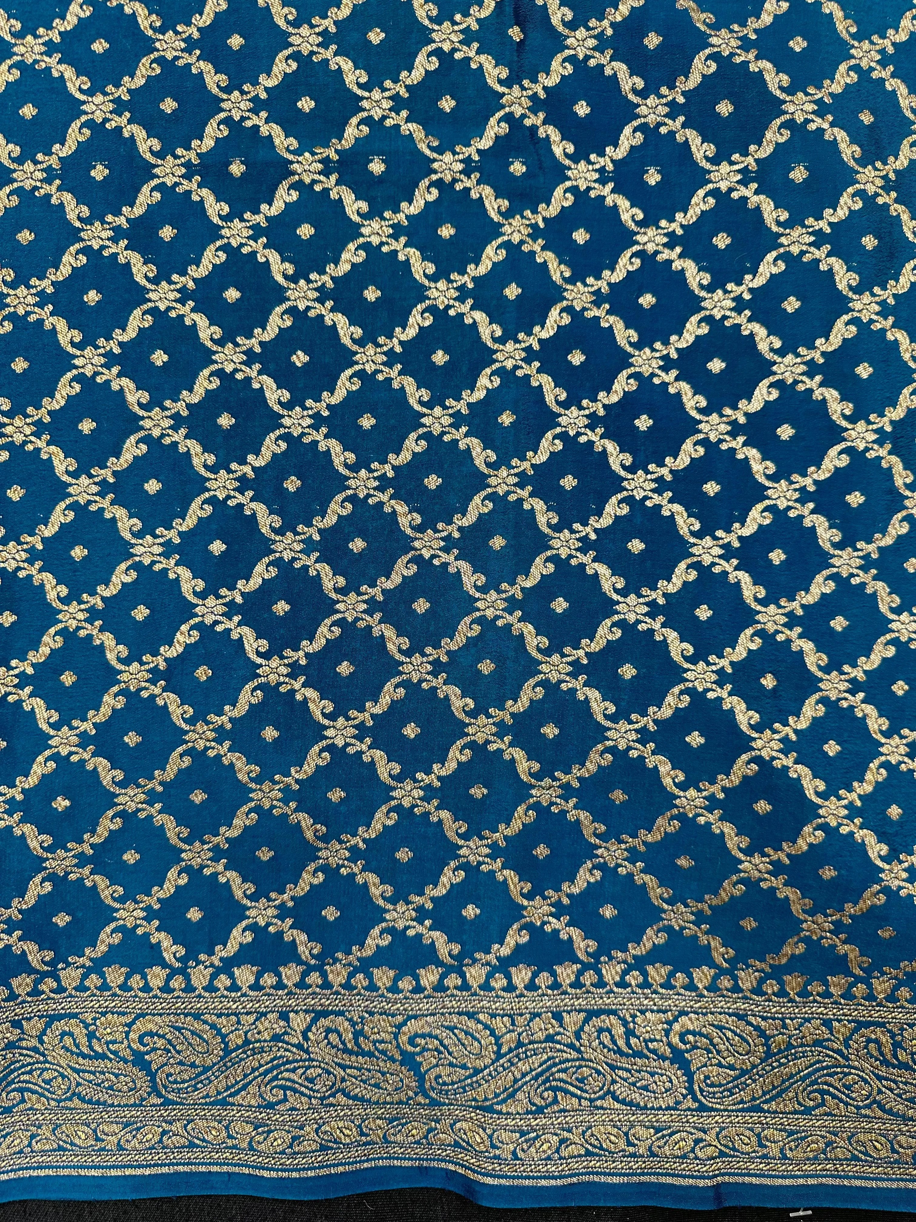 Pure Banarasi crepe silk saree with rich zari work and soft flowing texture – ideal for weddings and festive occasions