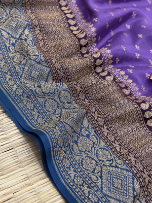 "Timeless Violet Pure Banarasi Crepe Silk Saree with intricate weaving, ideal for weddings and celebrations. The saree features a luxurious drape and vibrant violet color."