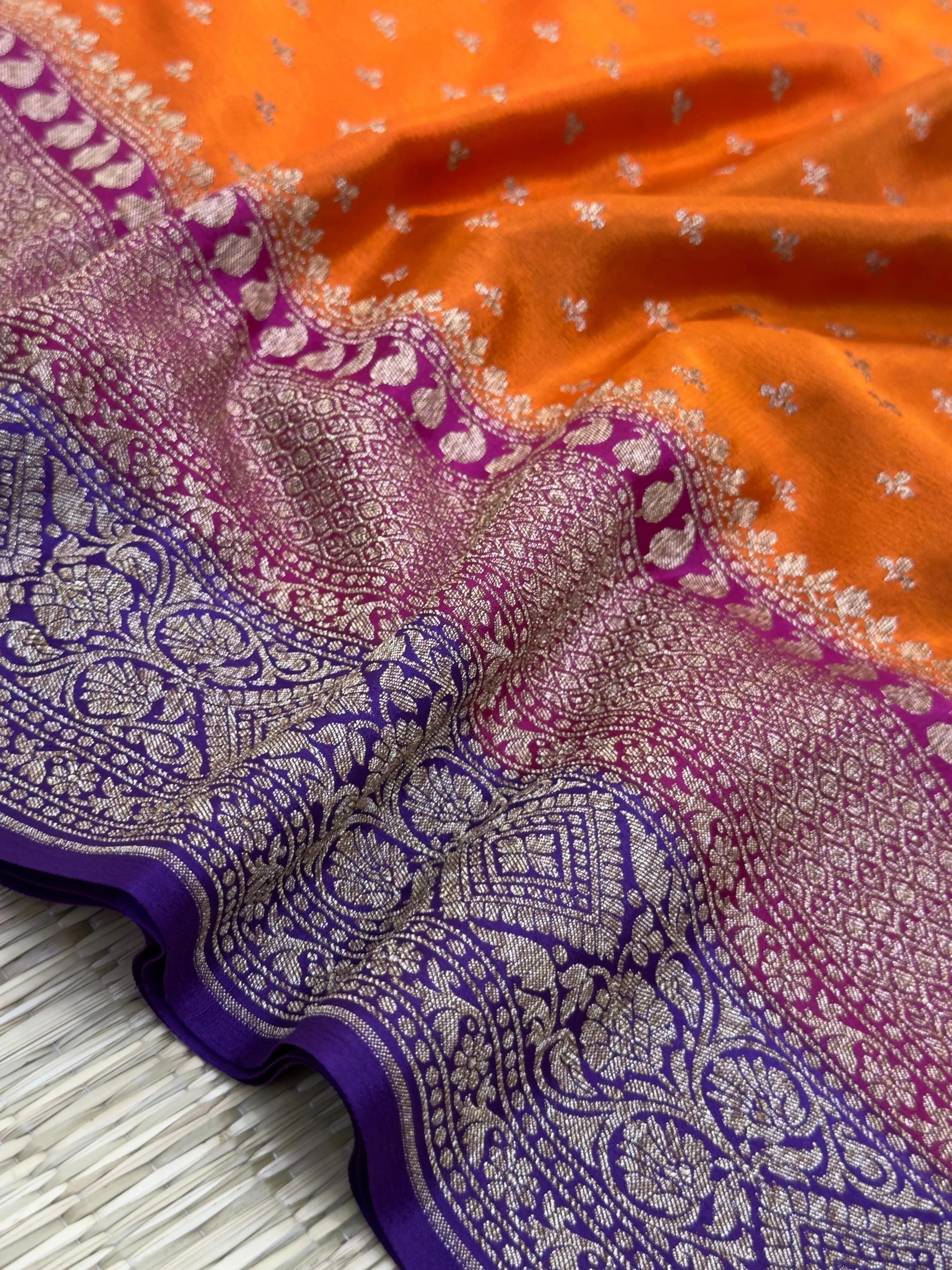 "Orange Pure Banarasi Crepe Silk Saree with intricate handwoven patterns, ideal for weddings and celebrations. Features a vibrant orange color and luxurious drape."