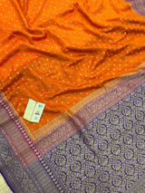 "Orange Pure Banarasi Crepe Silk Saree with intricate handwoven patterns, ideal for weddings and celebrations. Features a vibrant orange color and luxurious drape."