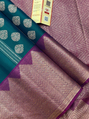 Woman draped in a Pure Kanjivaram Silk Saree with rich silk texture, vibrant colors, and traditional zari border, ideal for weddings and festivals.