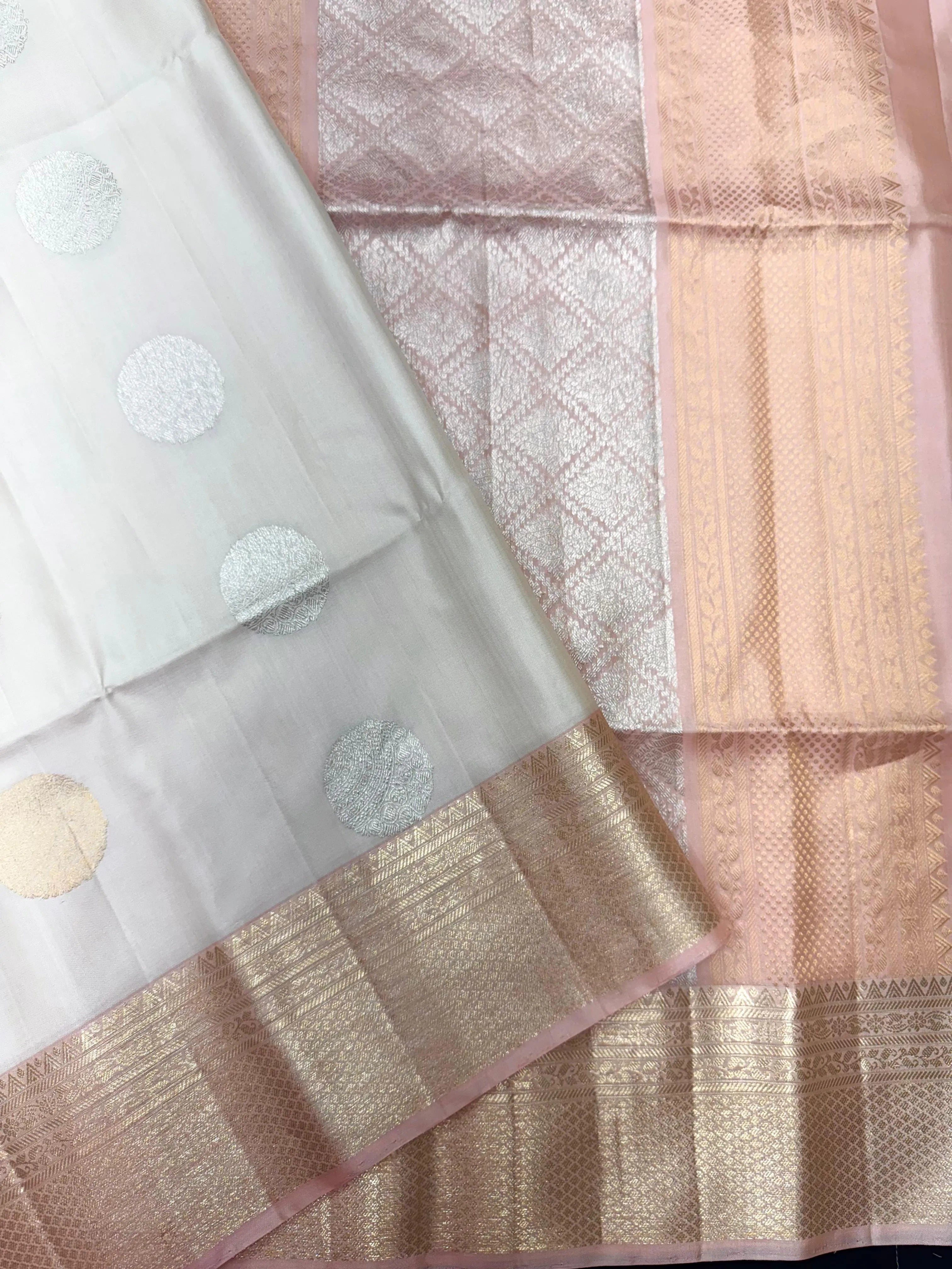 Pure Kanjivaram silk saree with golden zari work and rich traditional drape – ideal for bridal and festive wear