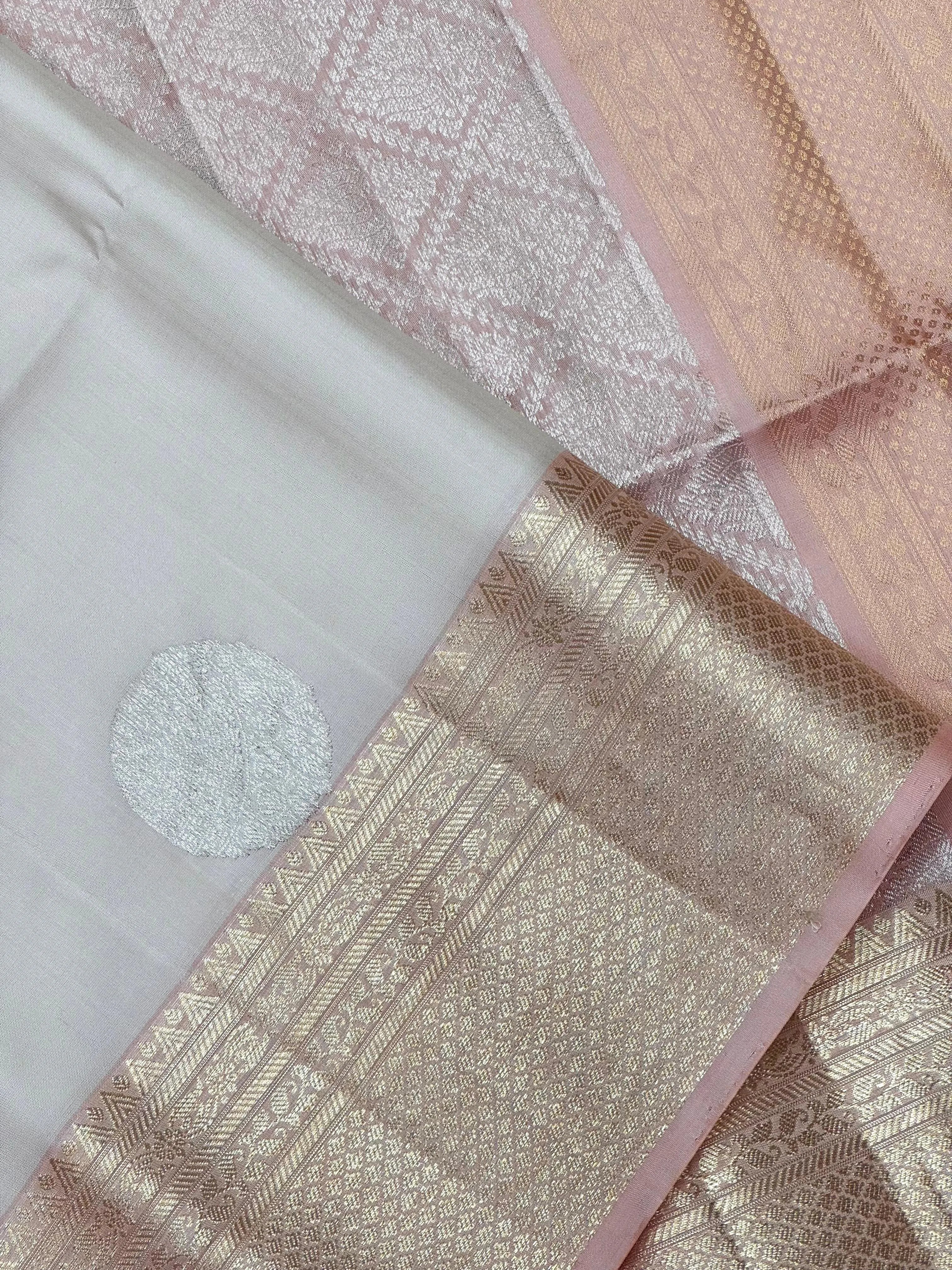 Pure Kanjivaram silk saree with golden zari work and rich traditional drape – ideal for bridal and festive wear