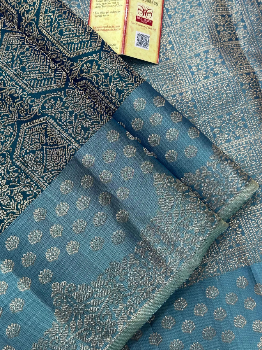 Woman draped in a Pure Kanjivaram Silk Saree with rich zari border, vibrant colors, and traditional motifs, ideal for weddings and festive occasions.