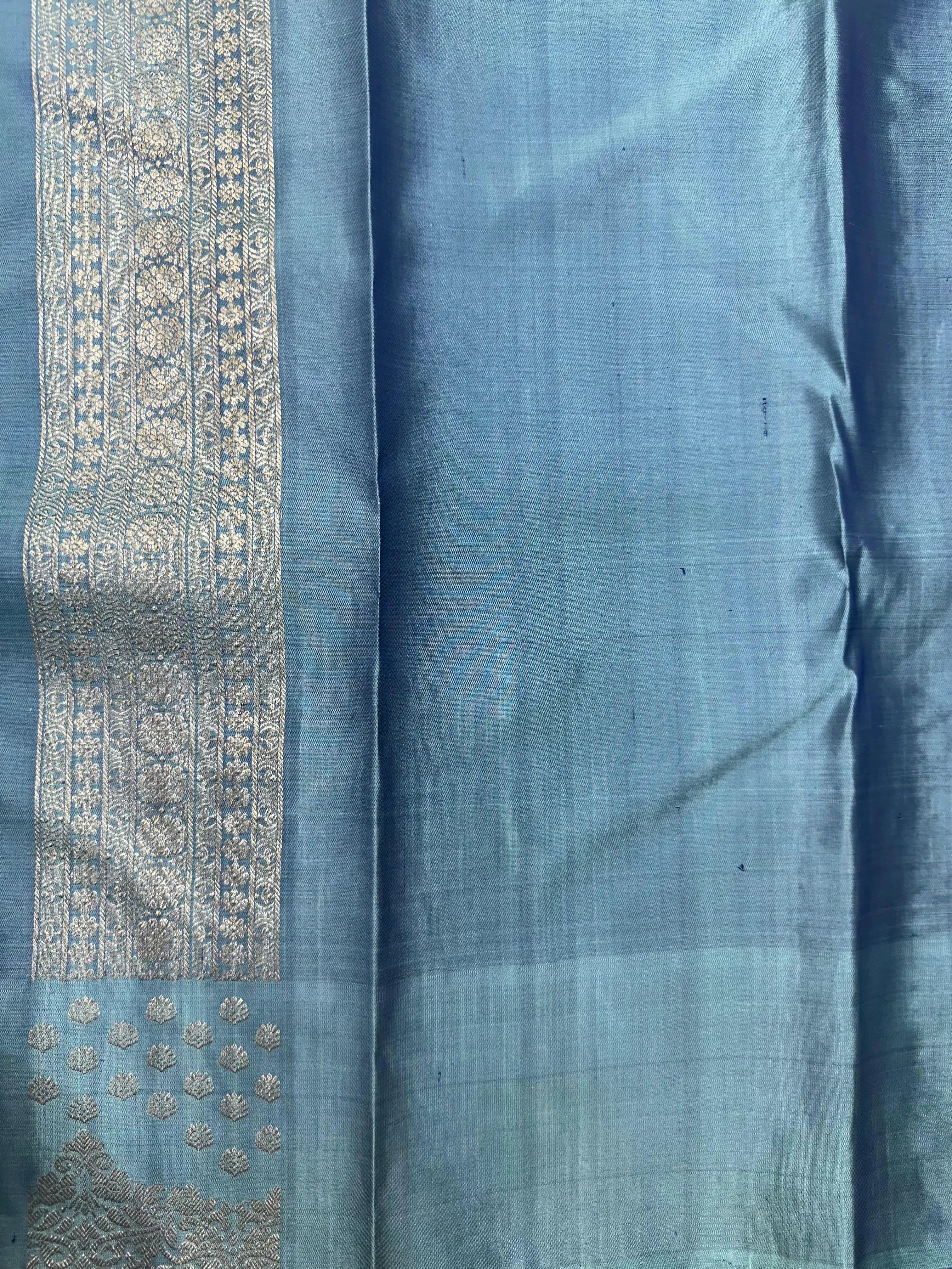 Woman draped in a Pure Kanjivaram Silk Saree with rich zari border, vibrant colors, and traditional motifs, ideal for weddings and festive occasions.