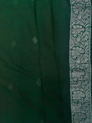 Woman wearing a Pure Khaddi Chiffon Saree with sheer, lightweight fabric and zari details, ideal for weddings and festive occasions.