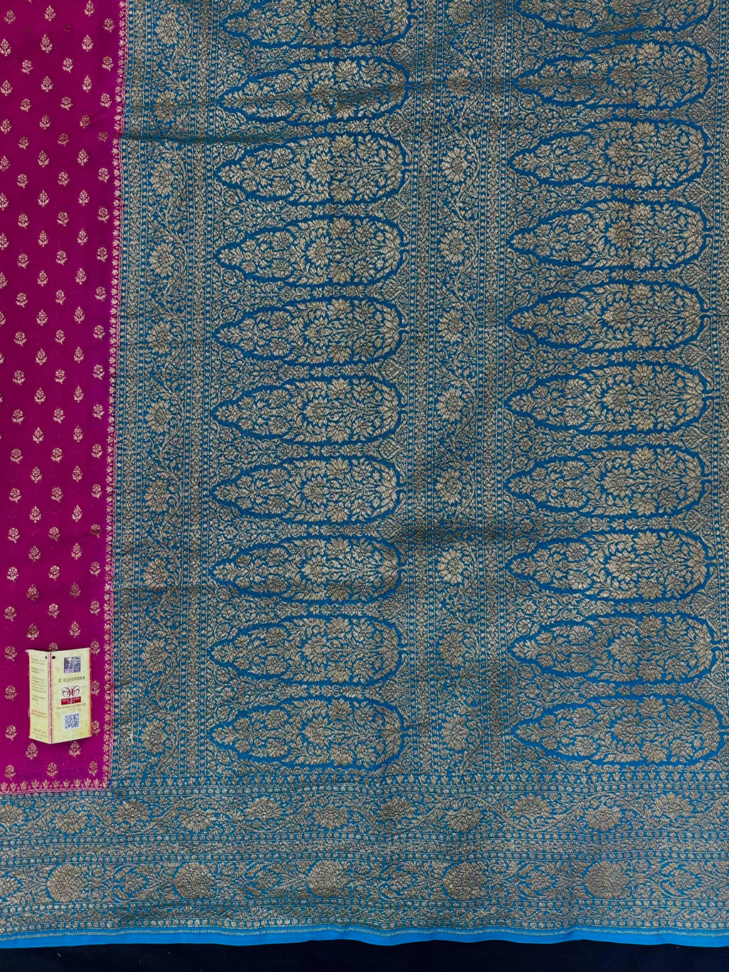 Woman wearing a Pure Khaddi Georgette Saree with rich zari work and flowing drape – ideal for festive and traditional occasions.
