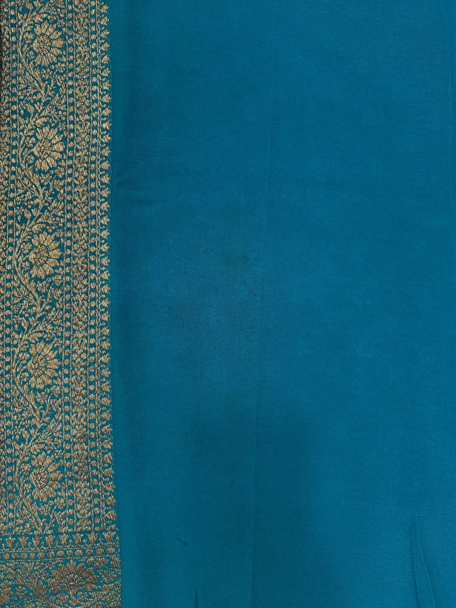 Woman wearing a Pure Khaddi Georgette Saree with rich zari work and flowing drape – ideal for festive and traditional occasions.