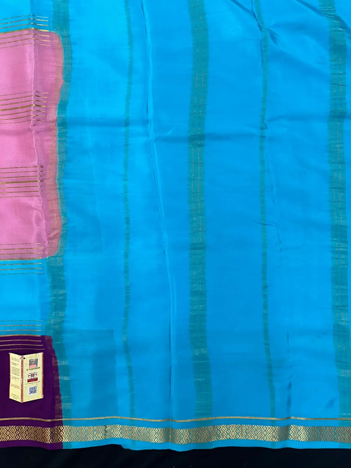Woman wearing a Pure Mysore Crepe Silk Saree with lustrous sheen and elegant zari border, perfect for weddings and festive occasions.