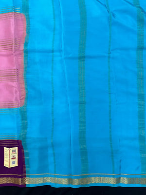 Woman wearing a Pure Mysore Crepe Silk Saree with lustrous sheen and elegant zari border, perfect for weddings and festive occasions.