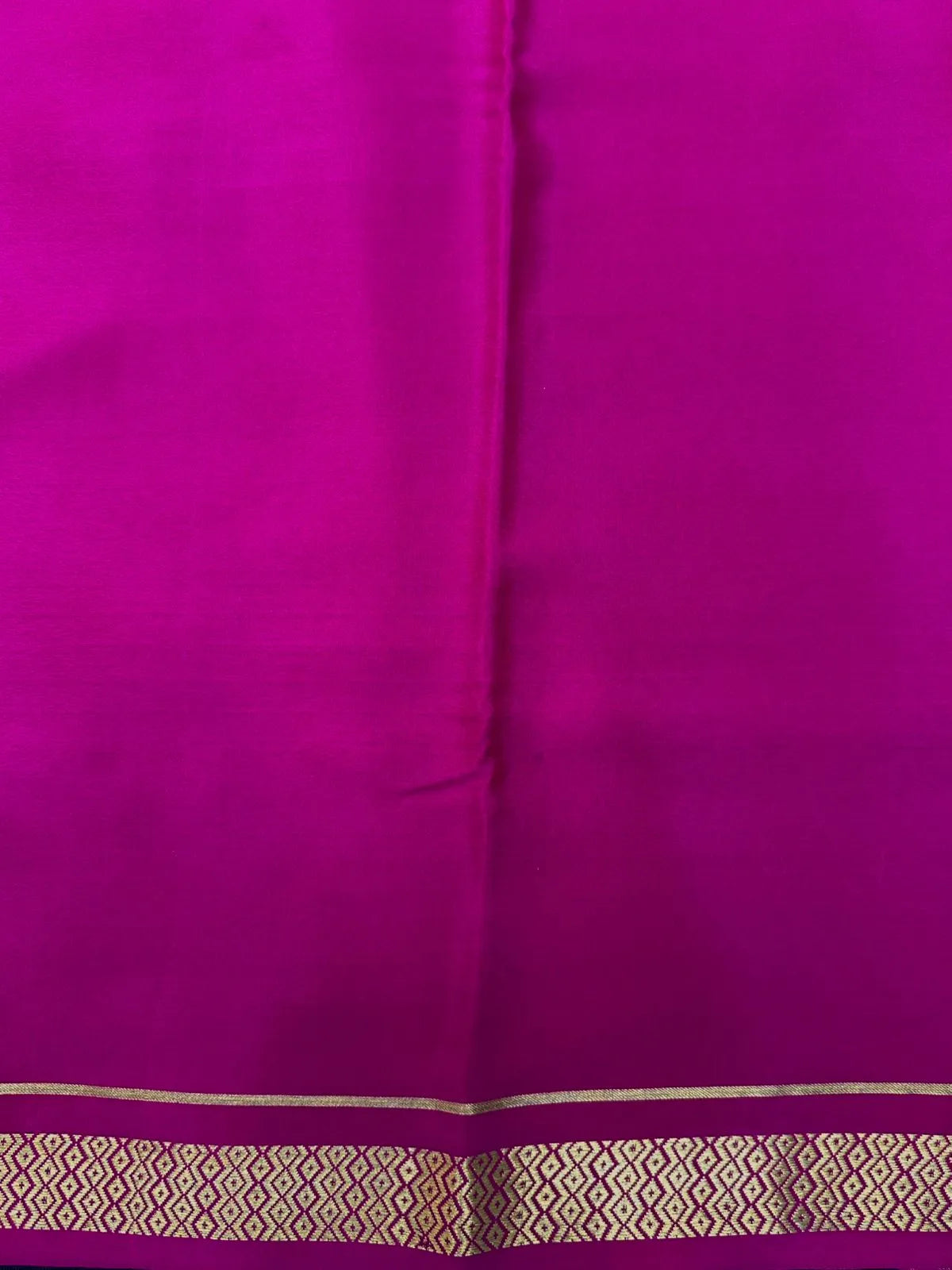 Woman wearing a Pure Mysore Crepe Silk Saree with lustrous sheen and elegant zari border, perfect for weddings and festive occasions.