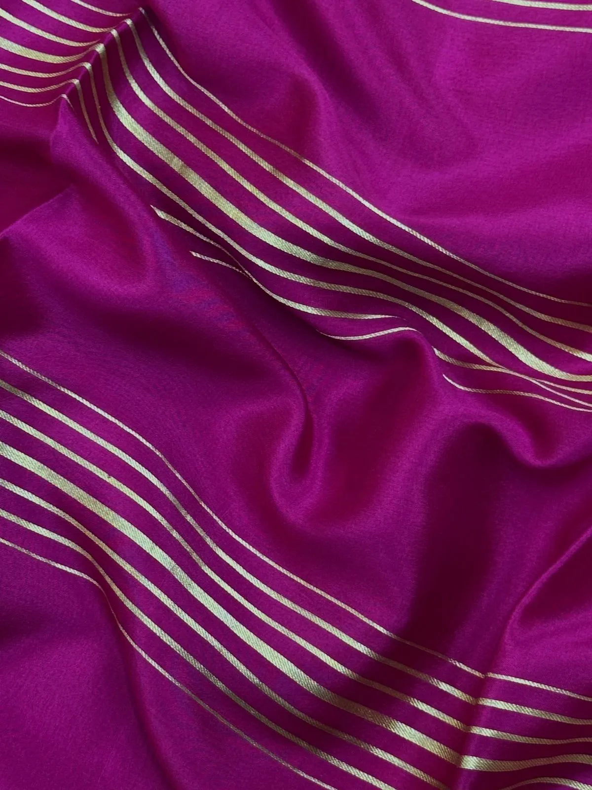 Woman wearing a Pure Mysore Crepe Silk Saree with lustrous sheen and elegant zari border, perfect for weddings and festive occasions.