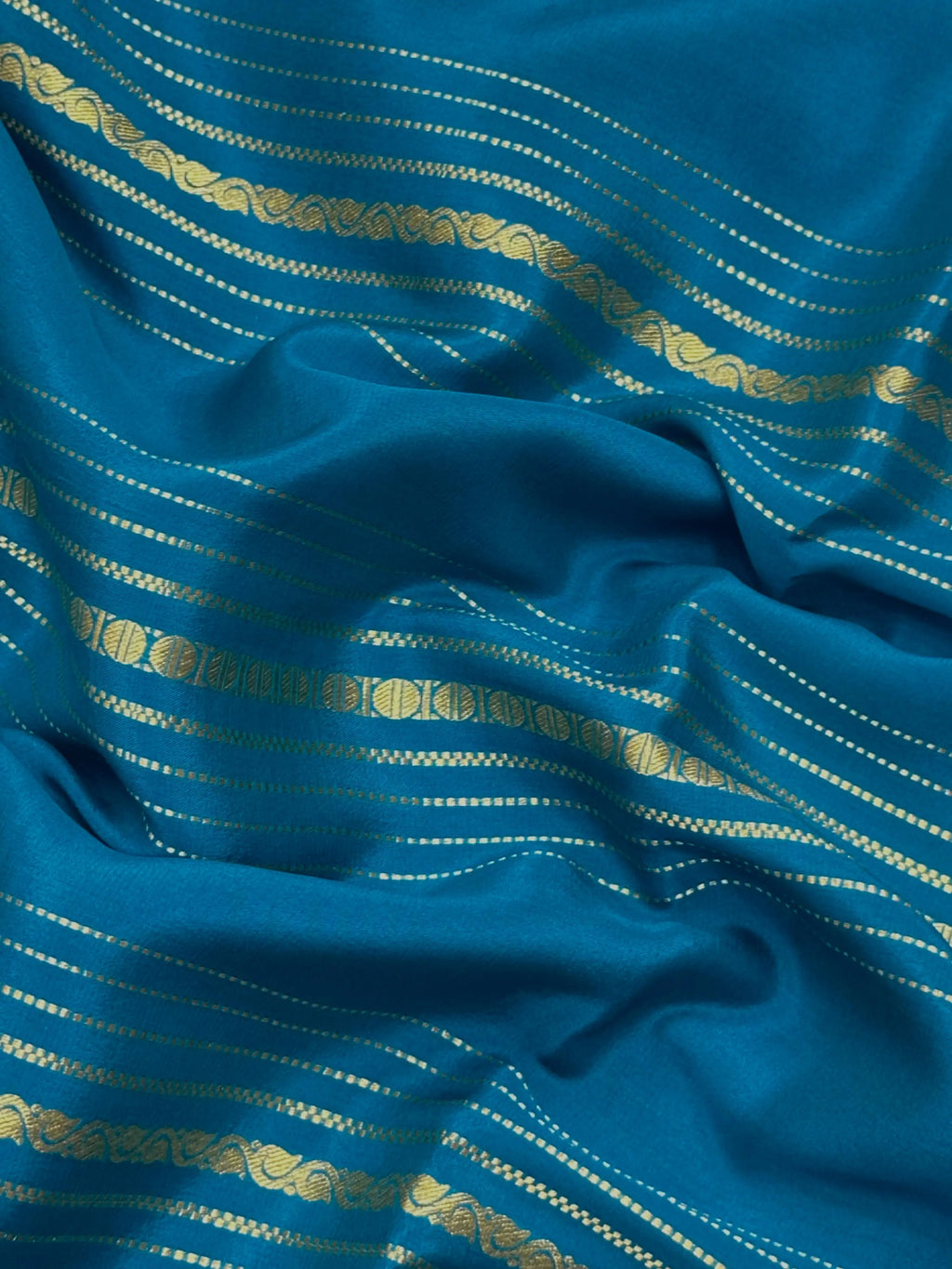 Woman wearing a Pure Mysore Silk Saree with smooth drape and zari border, perfect for weddings and traditional South Indian events.