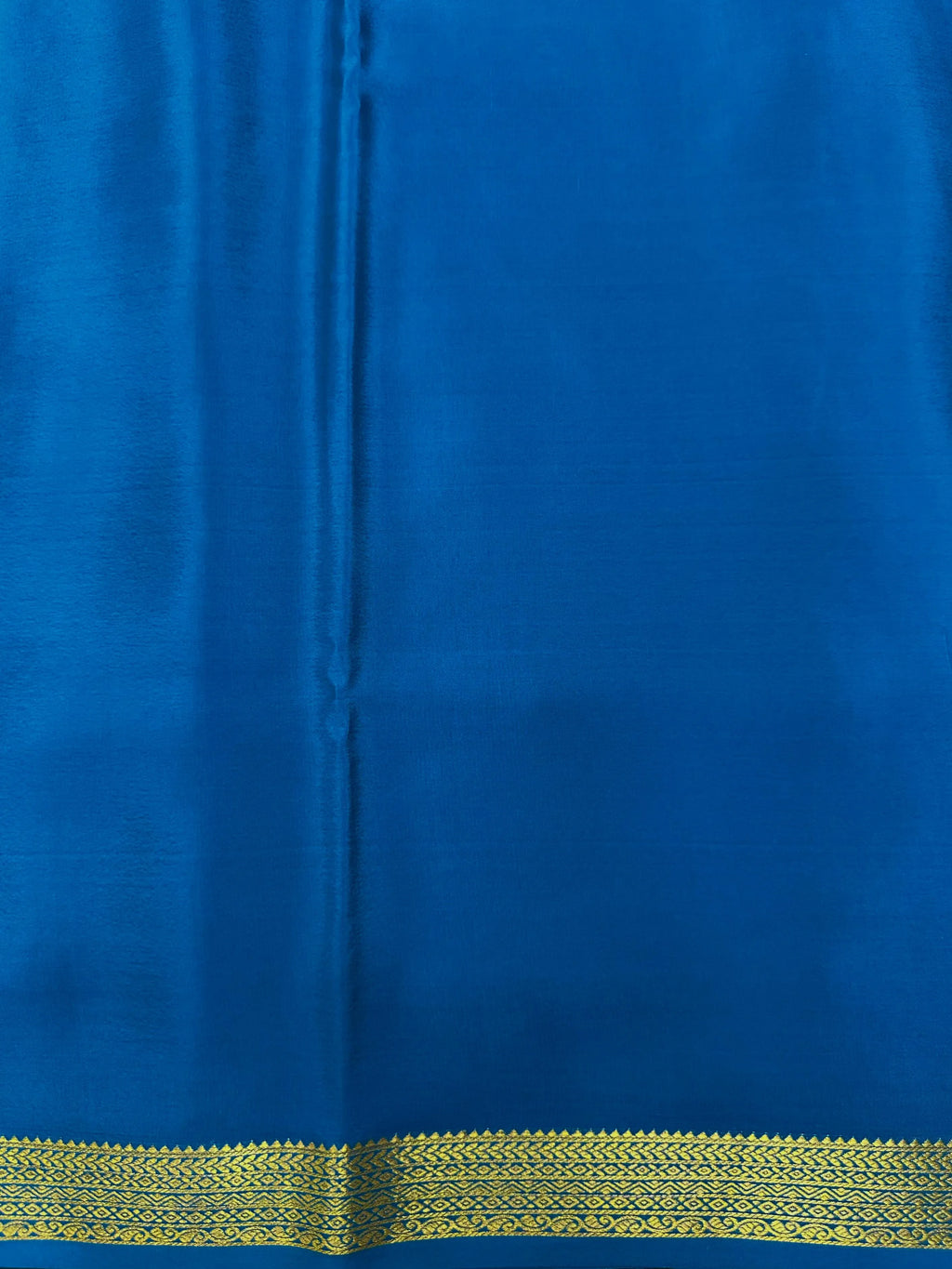 Woman wearing a Pure Mysore Silk Saree with smooth drape and zari border, perfect for weddings and traditional South Indian events.