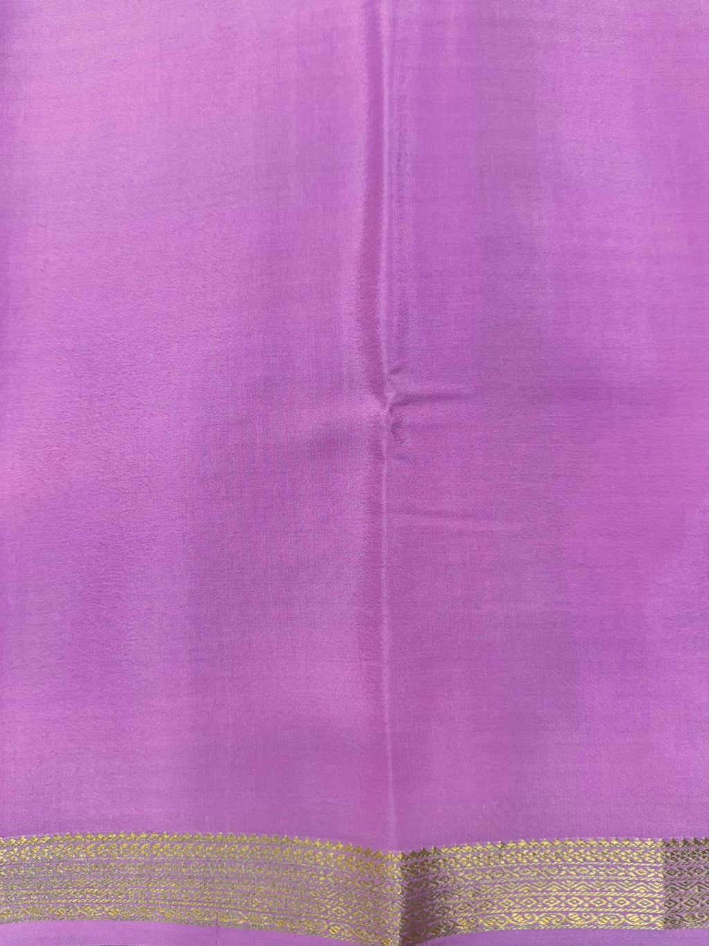 Woman wearing a Pure Mysore Silk Saree with smooth drape and zari border, perfect for weddings and traditional South Indian events.