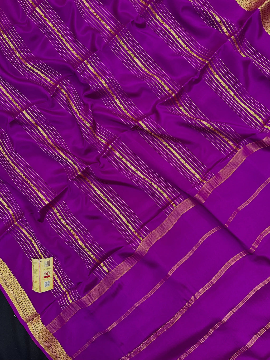 Woman wearing a Pure Mysore Silk Saree with smooth drape and zari border, perfect for weddings and traditional South Indian events.