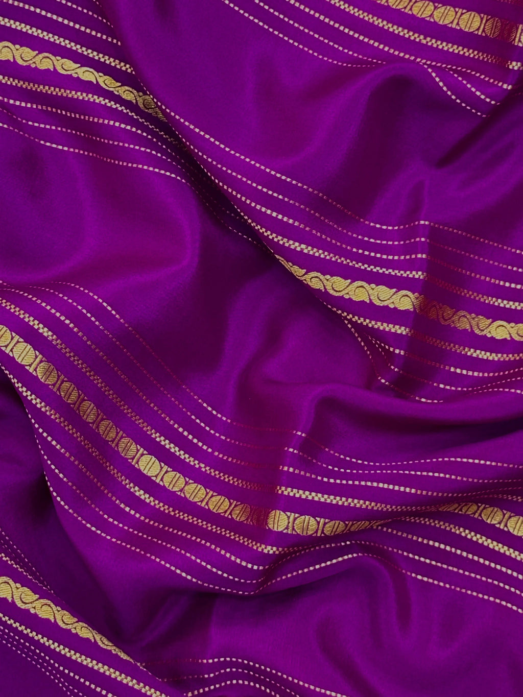 Woman wearing a Pure Mysore Silk Saree with smooth drape and zari border, perfect for weddings and traditional South Indian events.