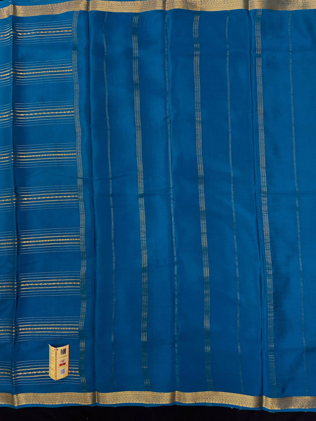 Woman wearing a Pure Mysore Silk Saree with smooth drape and zari border, perfect for weddings and traditional South Indian events.