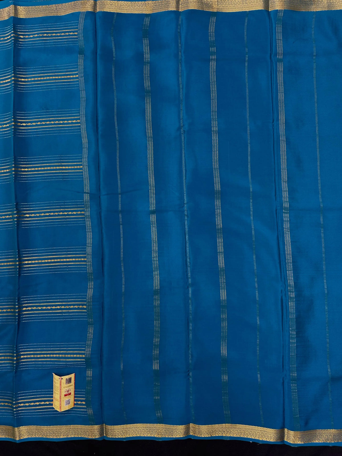 Woman wearing a Pure Mysore Silk Saree with smooth drape and zari border, perfect for weddings and traditional South Indian events.