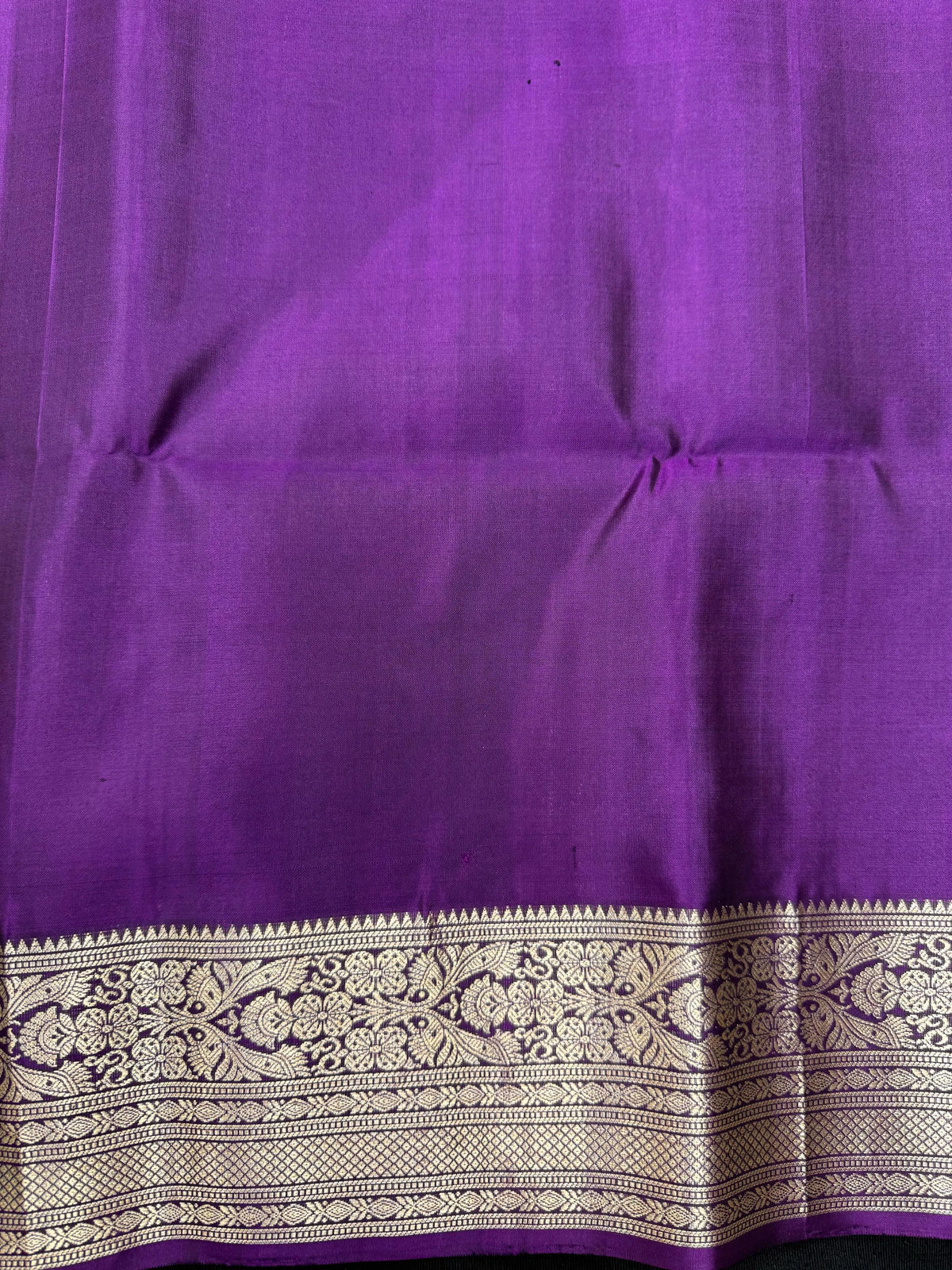 Woman draped in a Pure Pochampally Saree showcasing handwoven Ikat patterns in vibrant colors, representing traditional Telangana craftsmanship.