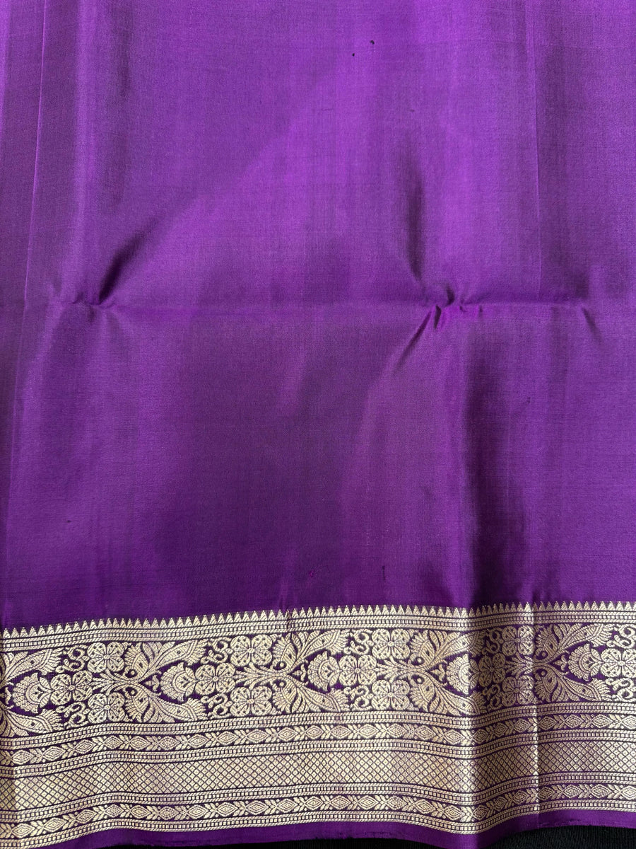 Woman draped in a Pure Pochampally Saree showcasing handwoven Ikat patterns in vibrant colors, representing traditional Telangana craftsmanship.