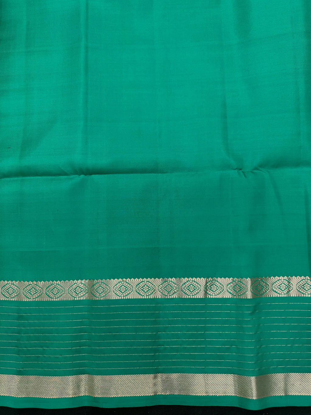 Woman wearing a Pure Silk Saree with glossy finish and intricate detailing, ideal for weddings and ethnic celebrations.