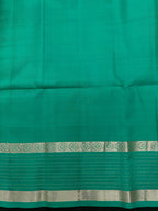 Woman wearing a Pure Silk Saree with glossy finish and intricate detailing, ideal for weddings and ethnic celebrations.