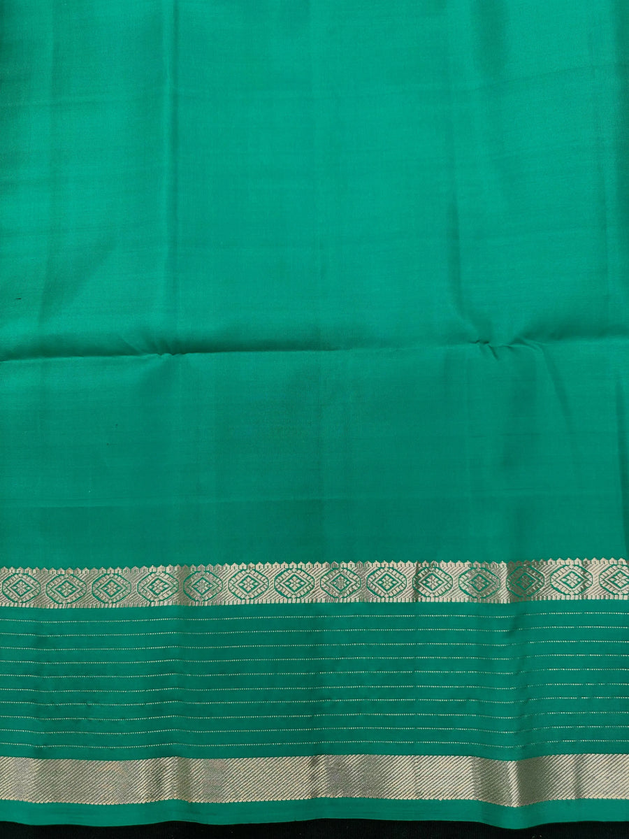 Woman wearing a Pure Silk Saree with glossy finish and intricate detailing, ideal for weddings and ethnic celebrations.