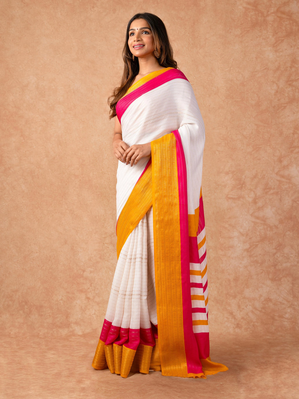 Woman draped in a Scarlet Chiffon Saree with vibrant red color and lightweight, flowy texture, perfect for weddings and festive events.