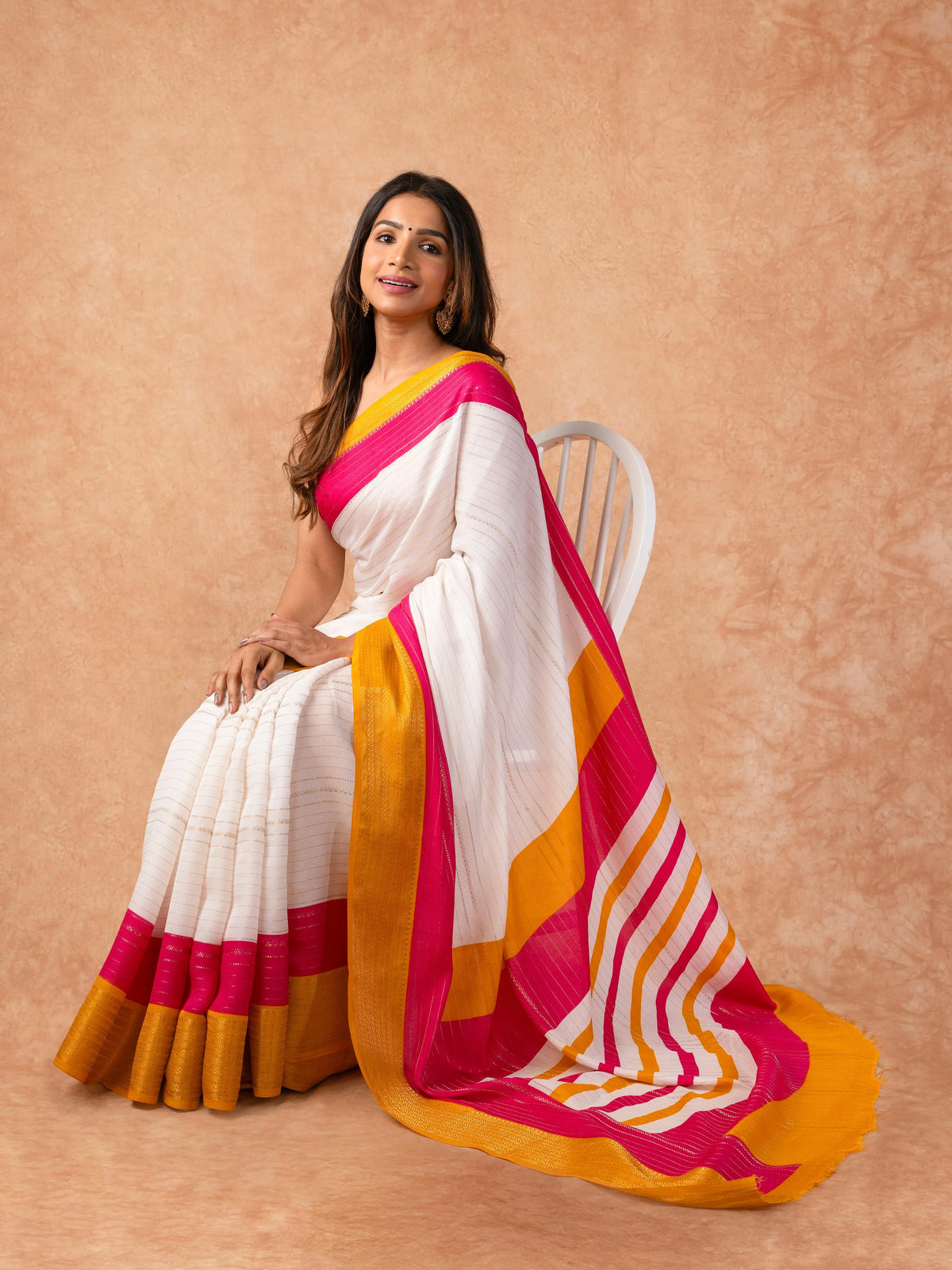 Woman draped in a Scarlet Chiffon Saree with vibrant red color and lightweight, flowy texture, perfect for weddings and festive events.